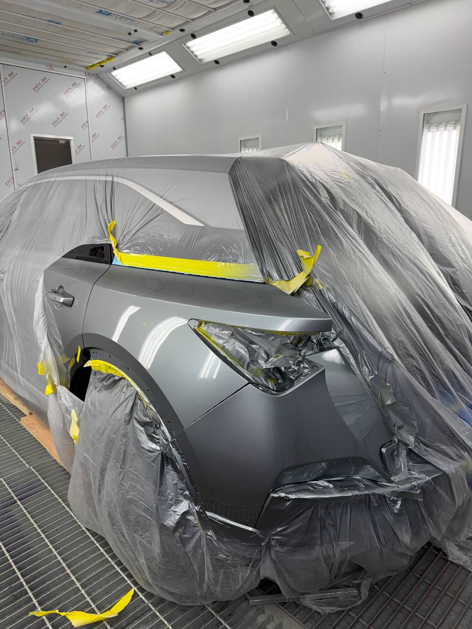 SUV masked for paint in the climate-controlled booth